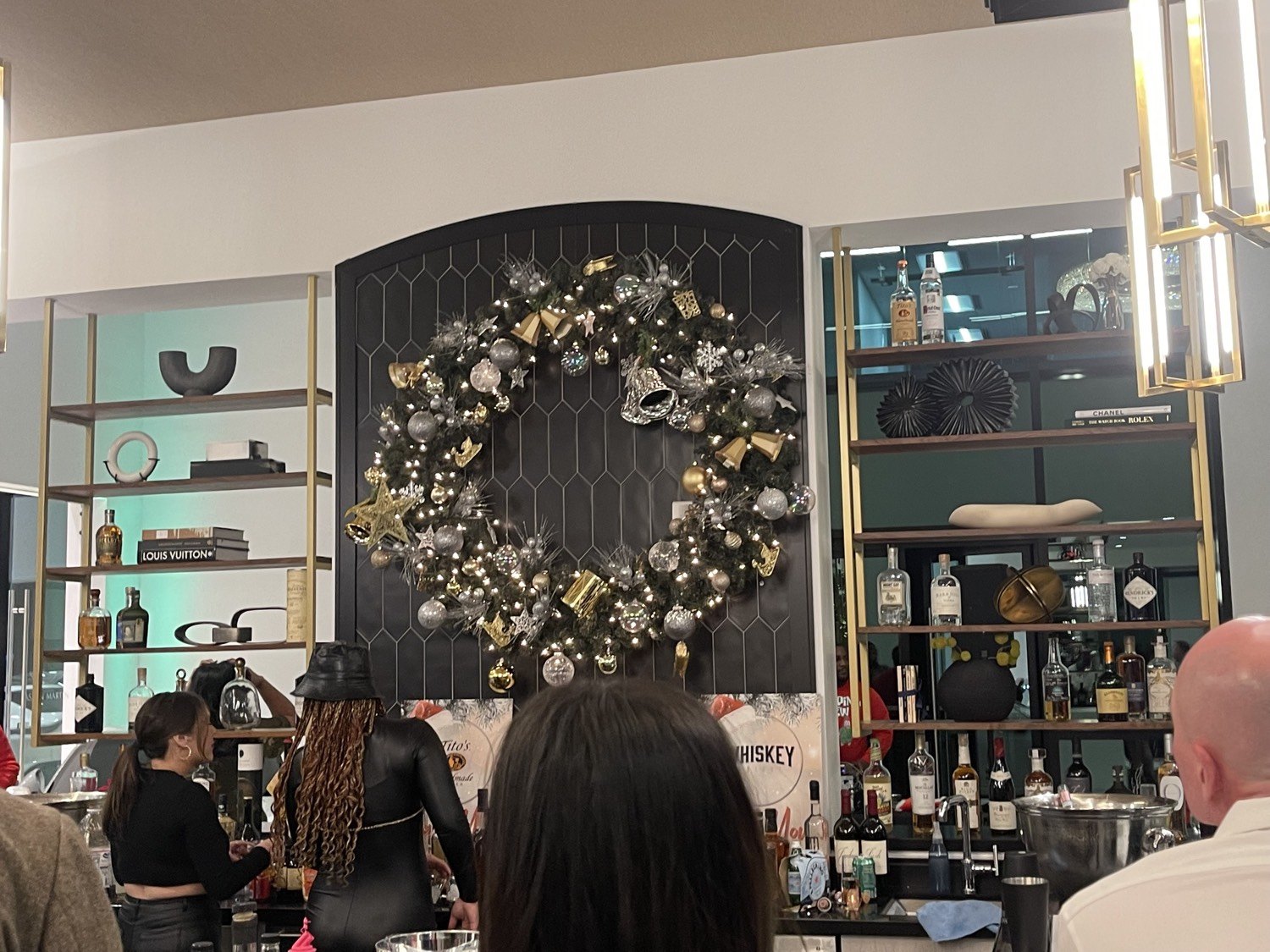Large gold and silver ornament wreath on a bar wall